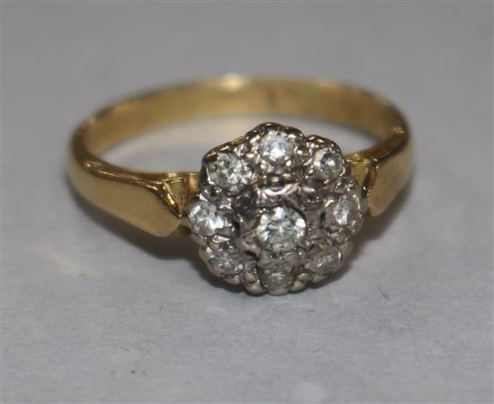 A diamond cluster ring, illusion-set in platinum on 18ct yellow gold shank